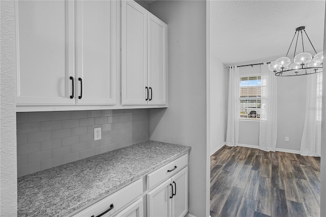 840 Livestock Loop, Saint Cloud, FL 34771 - kitchen featuring decorative backsplash, dark wood-style floors, white cabinetry, and light stone countertops