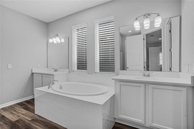 840 Livestock Loop, Saint Cloud, FL 34771 - bathroom featuring a garden tub, vanity, and wood finished floors