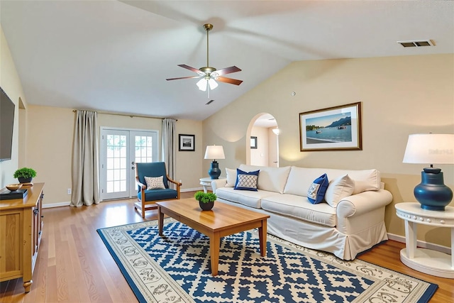 1073 Sadie Ln, Winter Garden, FL 34787 - living room featuring ceiling fan, light wood-type flooring, arched walkways, and vaulted ceiling