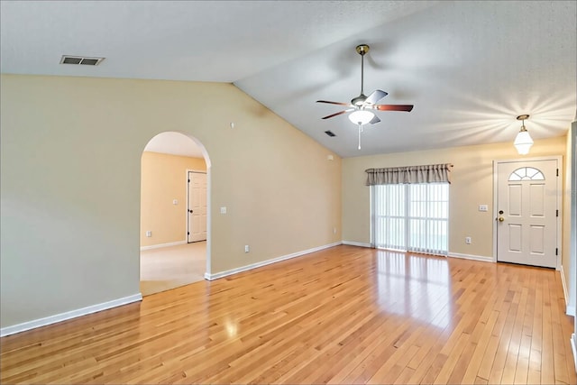 1073 Sadie Ln, Winter Garden, FL 34787 - empty room featuring a ceiling fan, light wood finished floors, arched walkways, and vaulted ceiling