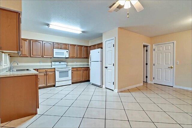1073 Sadie Ln, Winter Garden, FL 34787 - kitchen featuring white appliances, light countertops, ceiling fan, and light tile patterned floors