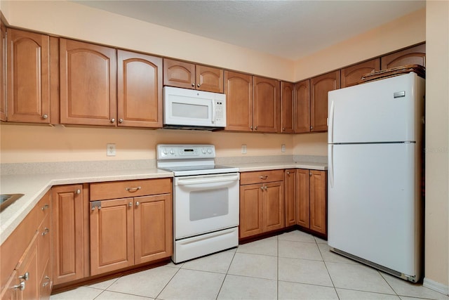 1073 Sadie Ln, Winter Garden, FL 34787 - kitchen featuring white appliances, brown cabinetry, light countertops, and light tile patterned floors