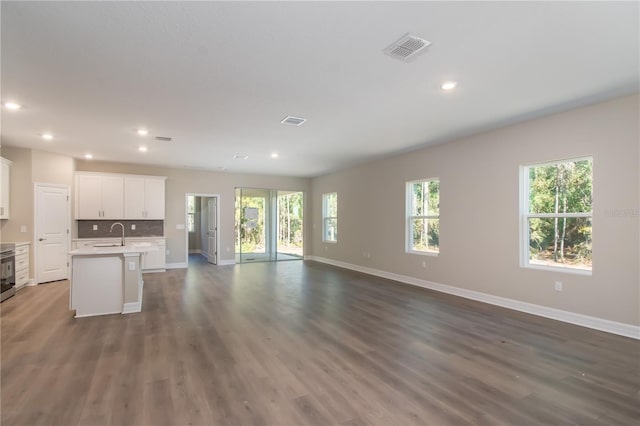 2833 E Newhaven St, Inverness, FL 34453 - unfurnished living room with dark wood-style flooring and recessed lighting