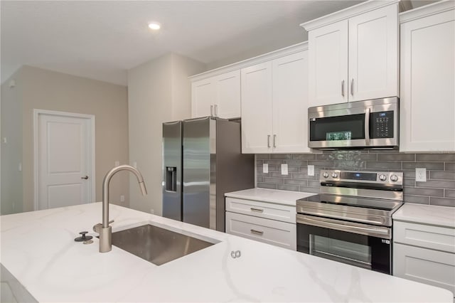 2833 E Newhaven St, Inverness, FL 34453 - kitchen featuring appliances with stainless steel finishes, backsplash, white cabinets, and recessed lighting