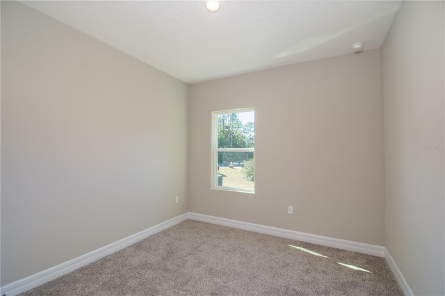 2833 E Newhaven St, Inverness, FL 34453 - carpeted spare room with baseboards and a smoke detector