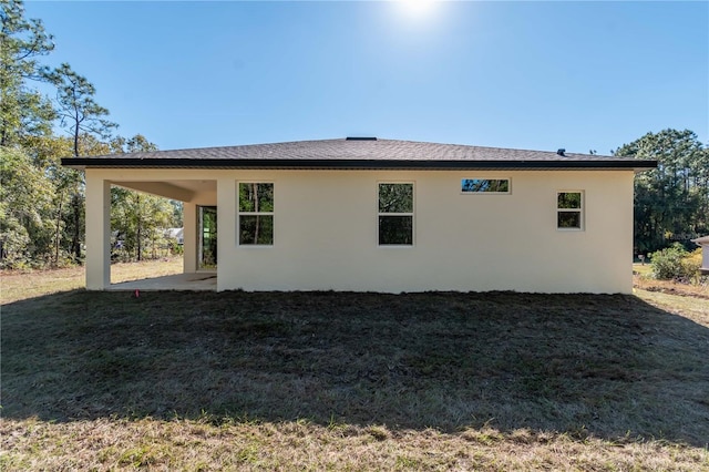 2833 E Newhaven St, Inverness, FL 34453 - back of house with stucco siding, a lawn, and a patio area