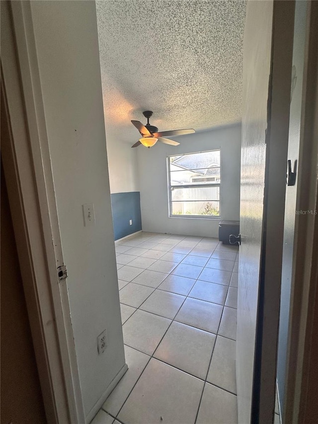 5265 Broken Arrow Dr, Kissimmee, FL 34746 - empty room featuring a textured ceiling, light tile patterned flooring, and ceiling fan