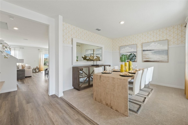 3413 Wynwood Forest Dr, Ocoee, FL 34761 - dining area with wallpapered walls, wood finished floors, and recessed lighting