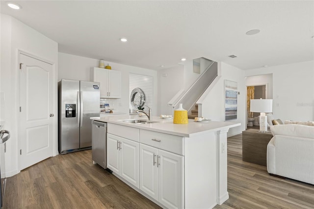 3413 Wynwood Forest Dr, Ocoee, FL 34761 - kitchen featuring stainless steel appliances, open floor plan, wood finished floors, white cabinetry, and recessed lighting