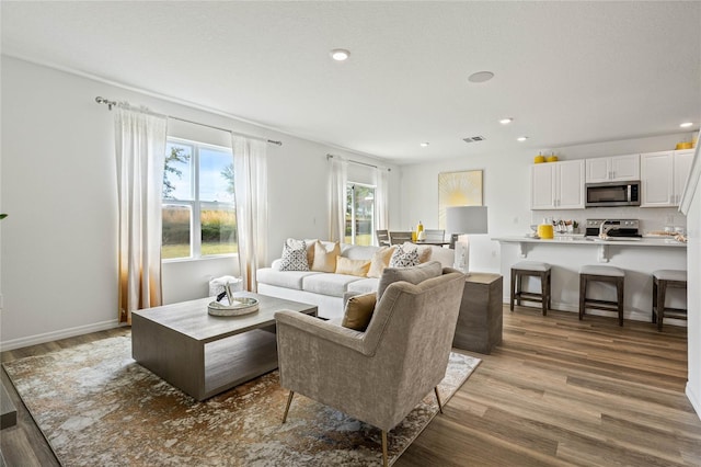 3413 Wynwood Forest Dr, Ocoee, FL 34761 - living area with light wood-style floors and recessed lighting