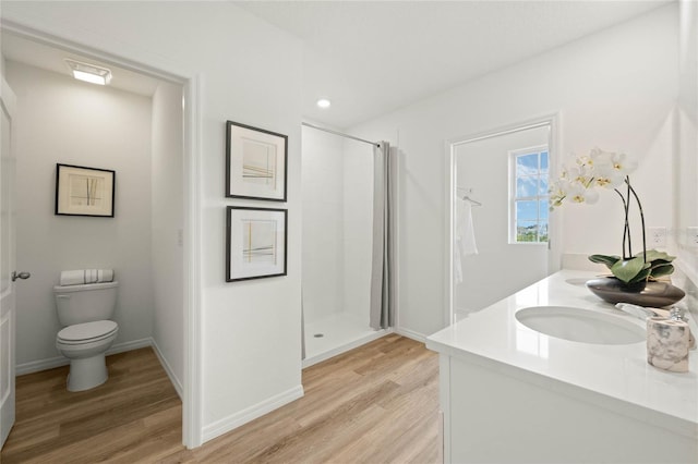 3413 Wynwood Forest Dr, Ocoee, FL 34761 - bathroom featuring wood finished floors, a shower stall, double vanity, and recessed lighting
