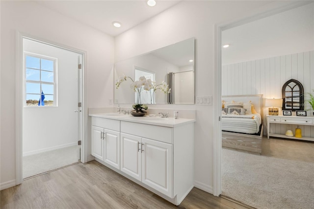 3413 Wynwood Forest Dr, Ocoee, FL 34761 - ensuite bathroom featuring double vanity, wood finished floors, and a shower with shower door