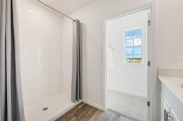 3413 Wynwood Forest Dr, Ocoee, FL 34761 - full bathroom with vanity, wood finished floors, and a tile shower