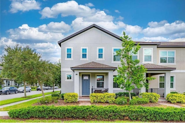 14007 Picard Aly, Winter Garden, FL 34787 - view of property with stucco siding, roof with shingles, and a porch