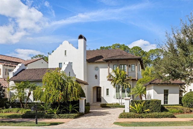 10143 Mattraw Pl, Golden Oak, FL 32836 - mediterranean / spanish-style home with a chimney, stucco siding, and decorative driveway