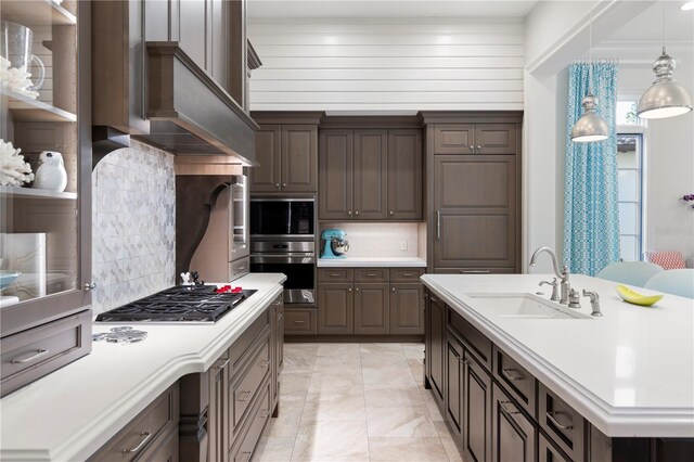 10143 Mattraw Pl, Golden Oak, FL 32836 - kitchen with appliances with stainless steel finishes, light countertops, decorative backsplash, and dark brown cabinets