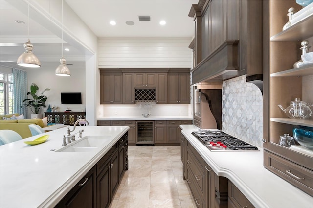 10143 Mattraw Pl, Golden Oak, FL 32836 - kitchen with wine cooler, stainless steel gas stovetop, light countertops, decorative backsplash, and recessed lighting