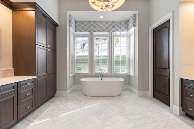 10143 Mattraw Pl, Golden Oak, FL 32836 - bathroom with marble look tile flooring, a soaking tub, and vanity