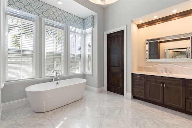 10143 Mattraw Pl, Golden Oak, FL 32836 - full bath featuring marble tiled flooring, a freestanding bath, and vanity