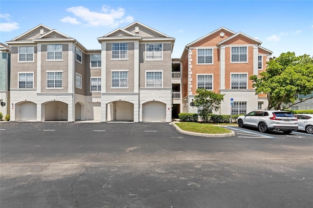 12843 Madison Pointe Unit 208, Orlando, FL 32821 - multi unit property featuring a garage and stucco siding