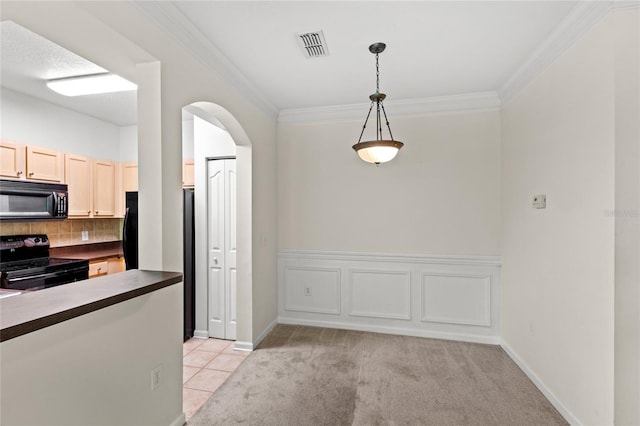 12843 Madison Pointe Unit 208, Orlando, FL 32821 - kitchen featuring black appliances, dark countertops, arched walkways, ornamental molding, and decorative backsplash
