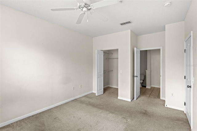 12843 Madison Pointe Unit 208, Orlando, FL 32821 - unfurnished bedroom featuring carpet, a ceiling fan, a closet, and a spacious closet