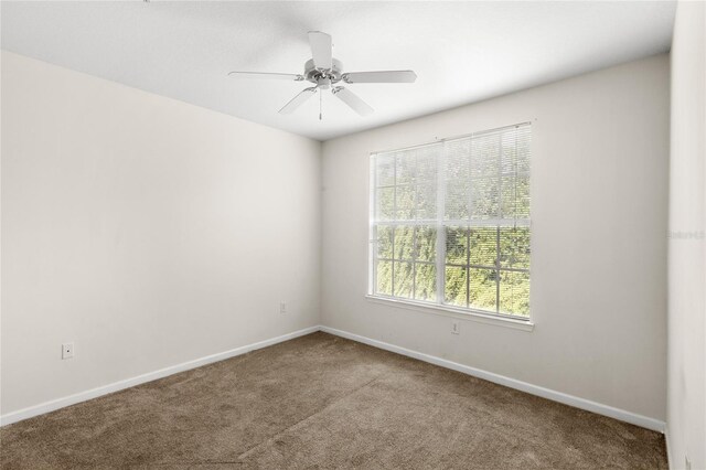 12843 Madison Pointe Unit 208, Orlando, FL 32821 - empty room with carpet flooring and ceiling fan