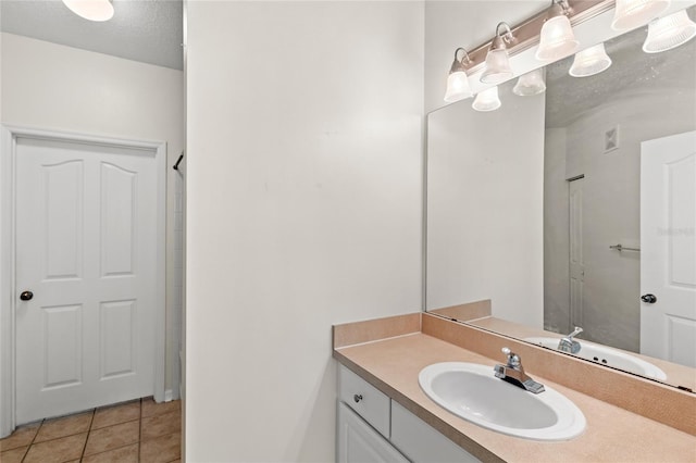 12843 Madison Pointe Unit 208, Orlando, FL 32821 - bathroom featuring vanity and tile patterned floors