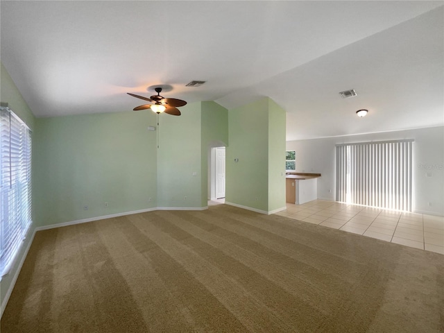 1877 Courtland Blvd, Deltona, FL 32738 - carpeted spare room with lofted ceiling, ceiling fan, and tile patterned flooring
