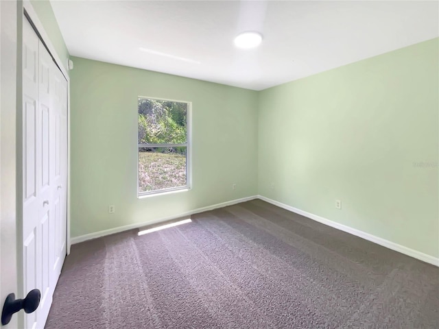 1877 Courtland Blvd, Deltona, FL 32738 - unfurnished bedroom featuring dark colored carpet and a closet