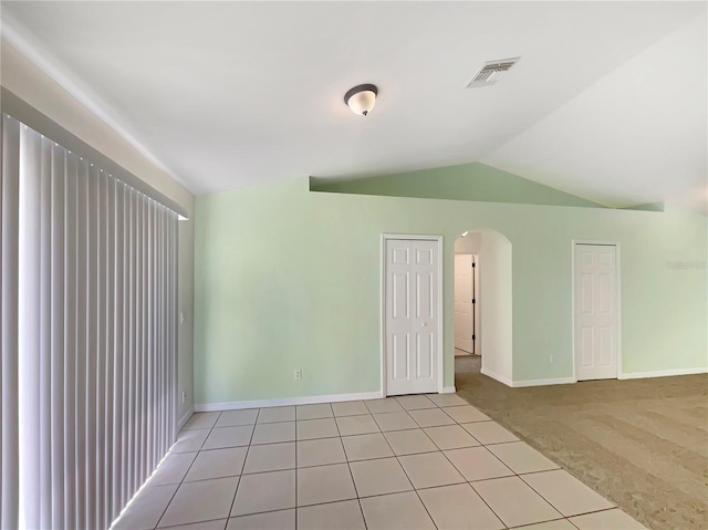 1877 Courtland Blvd, Deltona, FL 32738 - spare room with carpet flooring, arched walkways, lofted ceiling, and tile patterned flooring