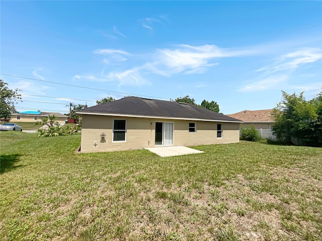 1877 Courtland Blvd, Deltona, FL 32738 - back of property featuring a lawn and a patio