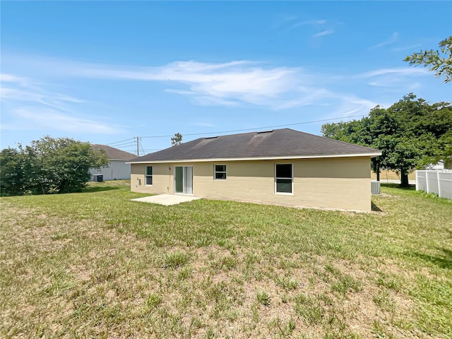 1877 Courtland Blvd, Deltona, FL 32738 - rear view of property with a lawn, a patio area, and a shingled roof
