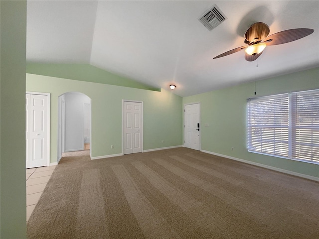 1877 Courtland Blvd, Deltona, FL 32738 - spare room featuring arched walkways, lofted ceiling, ceiling fan, and carpet floors