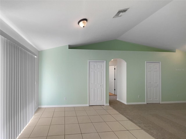 1877 Courtland Blvd, Deltona, FL 32738 - unfurnished room featuring arched walkways, lofted ceiling, light carpet, and light tile patterned flooring