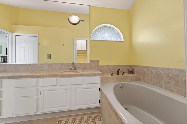 5704 Bay Side Dr, Orlando, FL 32819 - bathroom with a garden tub, vanity, and tile patterned floors