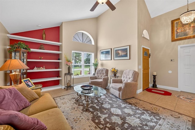 5704 Bay Side Dr, Orlando, FL 32819 - living room featuring tile patterned flooring, ceiling fan, high vaulted ceiling, and a chandelier