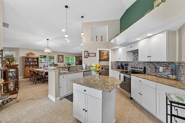 5704 Bay Side Dr, Orlando, FL 32819 - kitchen with stainless steel appliances, a peninsula, tasteful backsplash, light stone countertops, and light tile patterned floors