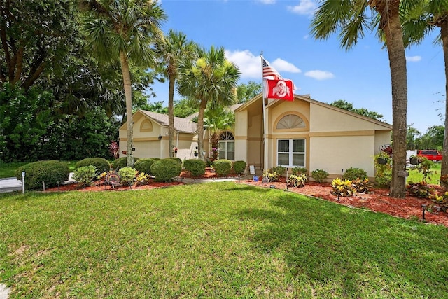 5704 Bay Side Dr, Orlando, FL 32819 - mediterranean / spanish-style house with stucco siding, a front yard, and an attached garage
