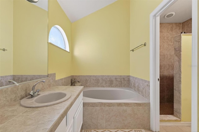 5704 Bay Side Dr, Orlando, FL 32819 - full bath featuring vanity, a garden tub, a stall shower, and tile patterned flooring