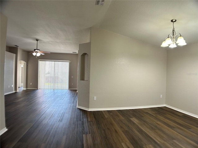 1433 Bluff Loop, Dundee, FL 33838 - unfurnished room featuring arched walkways, dark wood-type flooring, a chandelier, a ceiling fan, and a textured ceiling