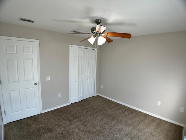 1433 Bluff Loop, Dundee, FL 33838 - unfurnished bedroom featuring dark colored carpet, a closet, and a ceiling fan