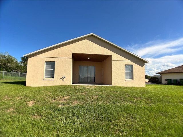 1433 Bluff Loop, Dundee, FL 33838 - back of house with stucco siding and a patio area
