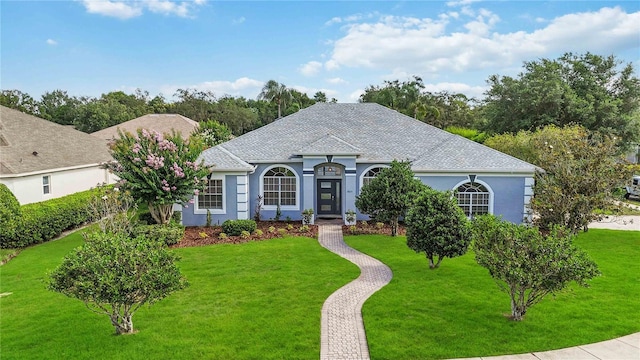 2865 Ashton Ter, Oviedo, FL 32765 - view of front of house featuring a front yard, stucco siding, and roof with shingles