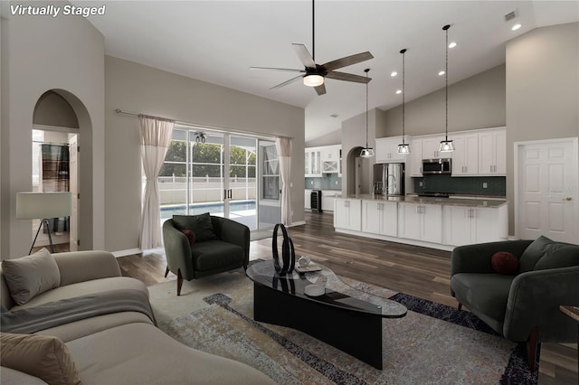 2865 Ashton Ter, Oviedo, FL 32765 - living room with a ceiling fan, dark wood-style flooring, high vaulted ceiling, arched walkways, and recessed lighting