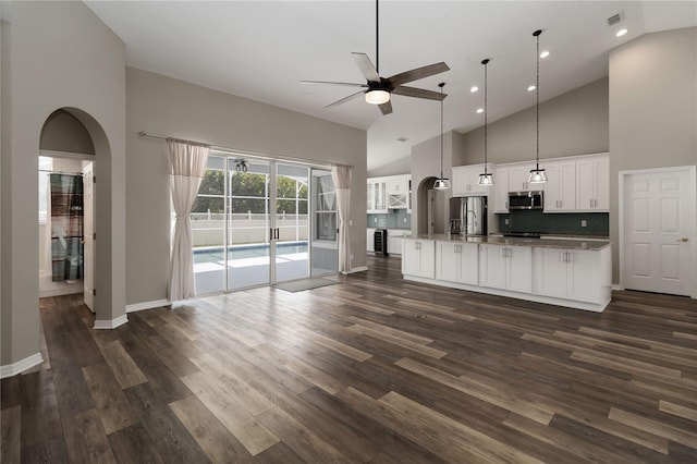 2865 Ashton Ter, Oviedo, FL 32765 - unfurnished living room with a ceiling fan, high vaulted ceiling, arched walkways, dark wood-style floors, and recessed lighting