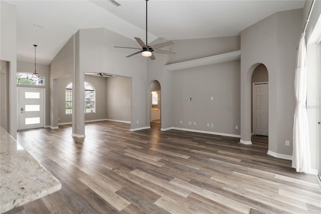 2865 Ashton Ter, Oviedo, FL 32765 - unfurnished living room with arched walkways, ceiling fan, high vaulted ceiling, and wood finished floors