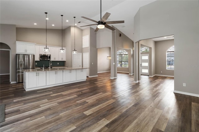 2865 Ashton Ter, Oviedo, FL 32765 - kitchen featuring appliances with stainless steel finishes, high vaulted ceiling, white cabinets, ceiling fan, and an island with sink