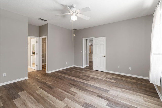 2865 Ashton Ter, Oviedo, FL 32765 - unfurnished bedroom featuring wood finished floors, connected bathroom, and ceiling fan
