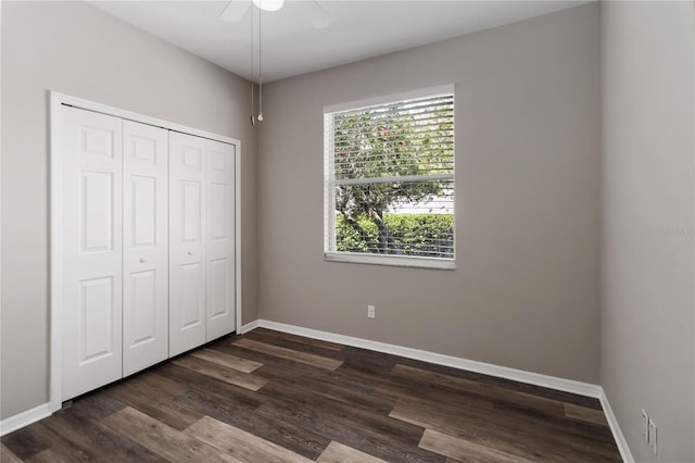 2865 Ashton Ter, Oviedo, FL 32765 - unfurnished bedroom featuring multiple windows, a closet, dark wood-style flooring, and a ceiling fan